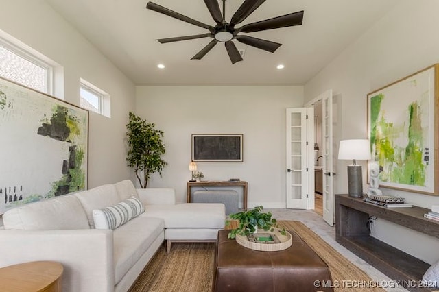 living room featuring wood-type flooring and ceiling fan