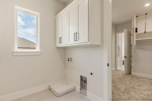 laundry area featuring washer hookup, hookup for an electric dryer, and cabinets