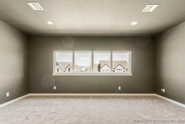 unfurnished room with light carpet