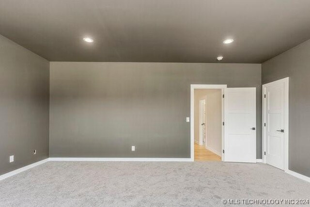 spare room with light colored carpet