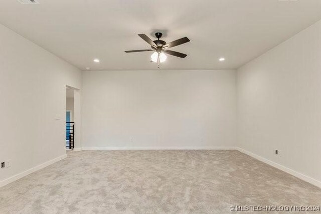 carpeted empty room with ceiling fan