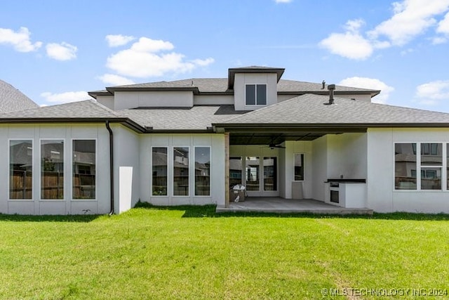 rear view of house featuring a yard, a patio, and ceiling fan