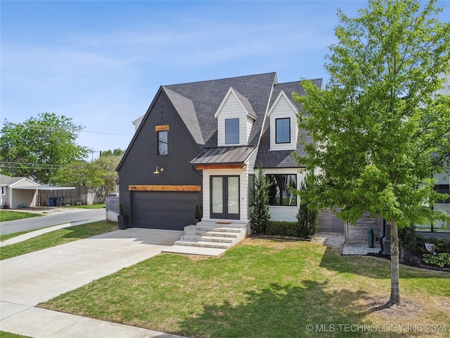 view of front of home featuring a front yard and a garage