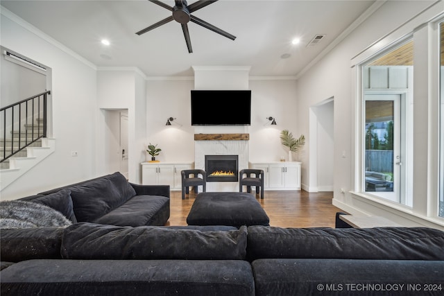 living room featuring crown molding, hardwood / wood-style flooring, and ceiling fan