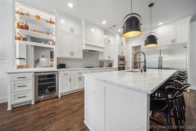 kitchen with white cabinets, beverage cooler, built in appliances, dark wood-type flooring, and sink