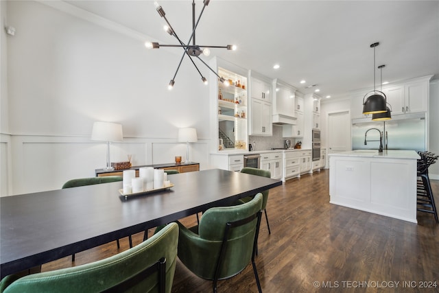 dining area with sink, a notable chandelier, and dark hardwood / wood-style flooring