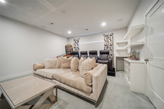 home theater room featuring light colored carpet