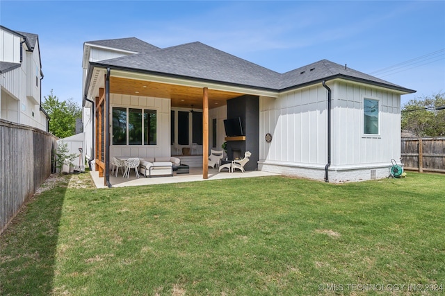 back of house featuring a patio, outdoor lounge area, and a yard