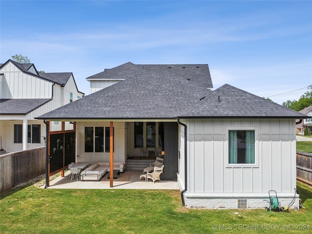 rear view of house with a patio and a yard