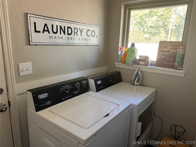 clothes washing area featuring washing machine and dryer