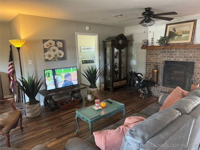 living room with ceiling fan, dark hardwood / wood-style flooring, and a fireplace