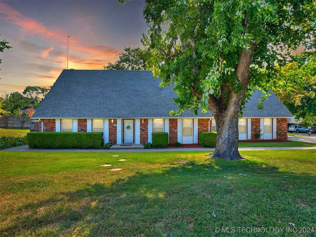 cape cod-style house with a yard