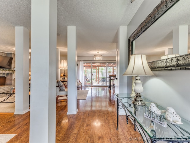 hallway featuring a textured ceiling and hardwood / wood-style flooring