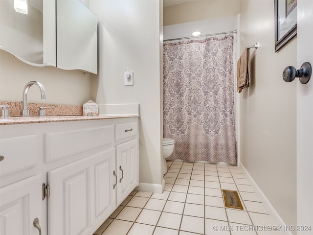 bathroom featuring tile patterned floors, curtained shower, vanity, and toilet