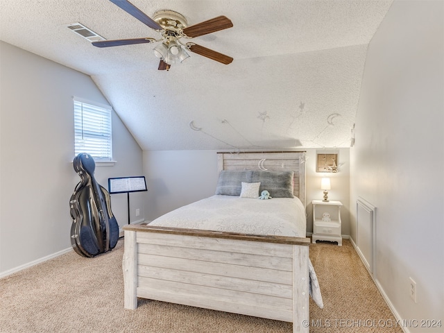 carpeted bedroom featuring ceiling fan, a textured ceiling, and vaulted ceiling