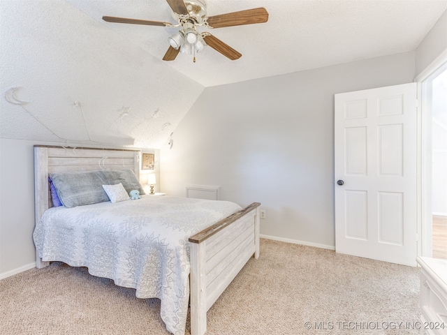 bedroom with a textured ceiling, ceiling fan, light colored carpet, and vaulted ceiling