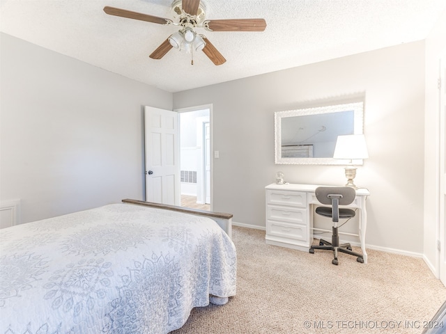 bedroom featuring light carpet, a textured ceiling, and ceiling fan