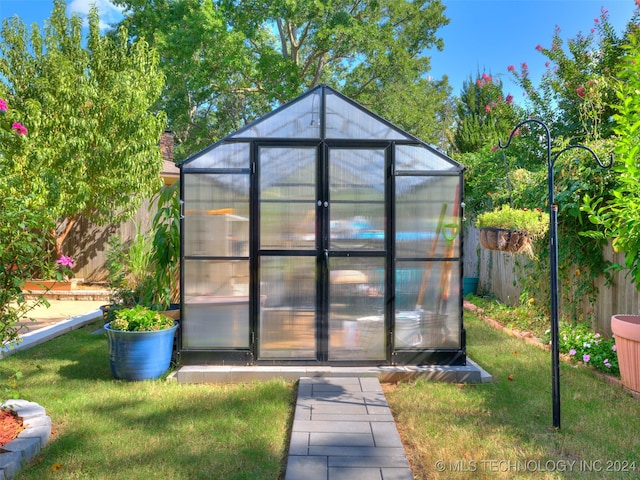 view of outbuilding with a lawn