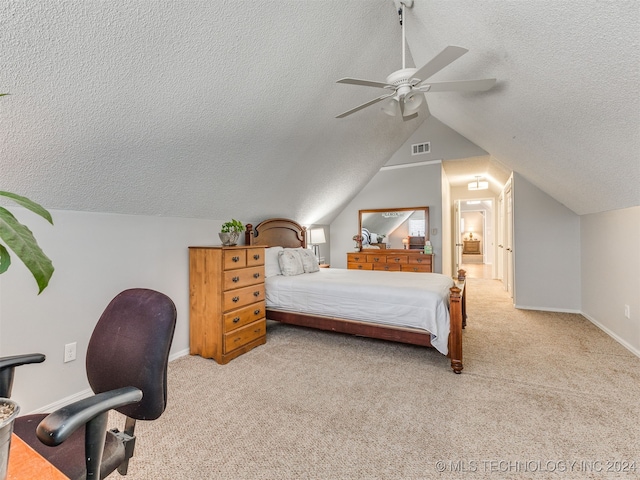 bedroom featuring ceiling fan, light colored carpet, lofted ceiling, and a textured ceiling