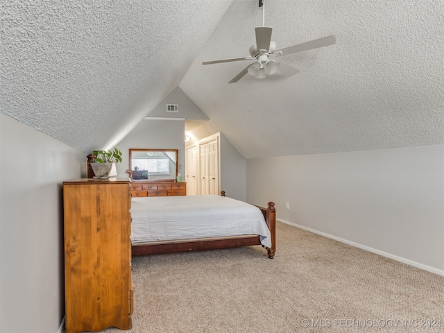 carpeted bedroom with a textured ceiling, ceiling fan, and lofted ceiling