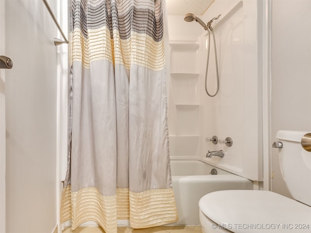 bathroom with tile patterned floors, a textured ceiling, and shower / tub combo