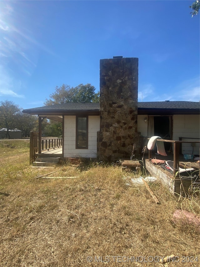 rear view of property featuring a yard