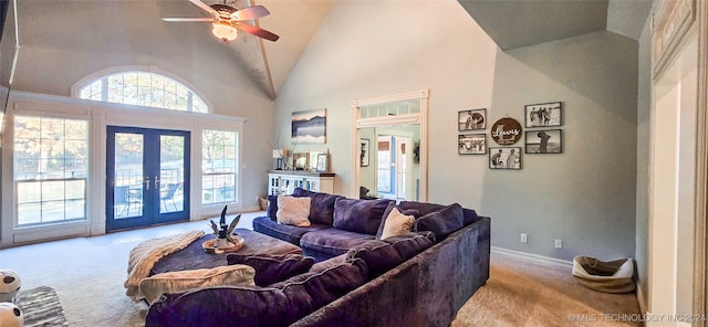 carpeted living room with french doors, ceiling fan, and high vaulted ceiling