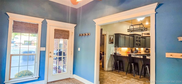 doorway to outside featuring crown molding