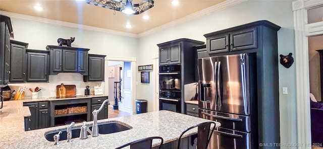 kitchen featuring wood-type flooring, black appliances, crown molding, light stone counters, and tasteful backsplash