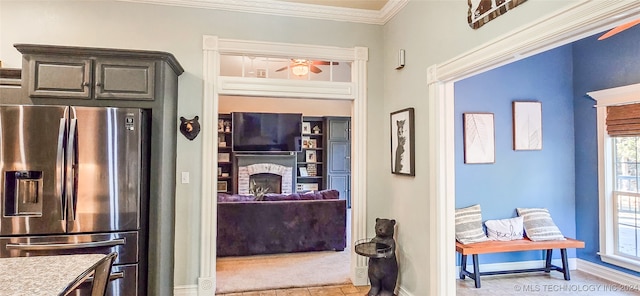 kitchen featuring crown molding, stainless steel fridge with ice dispenser, and ceiling fan