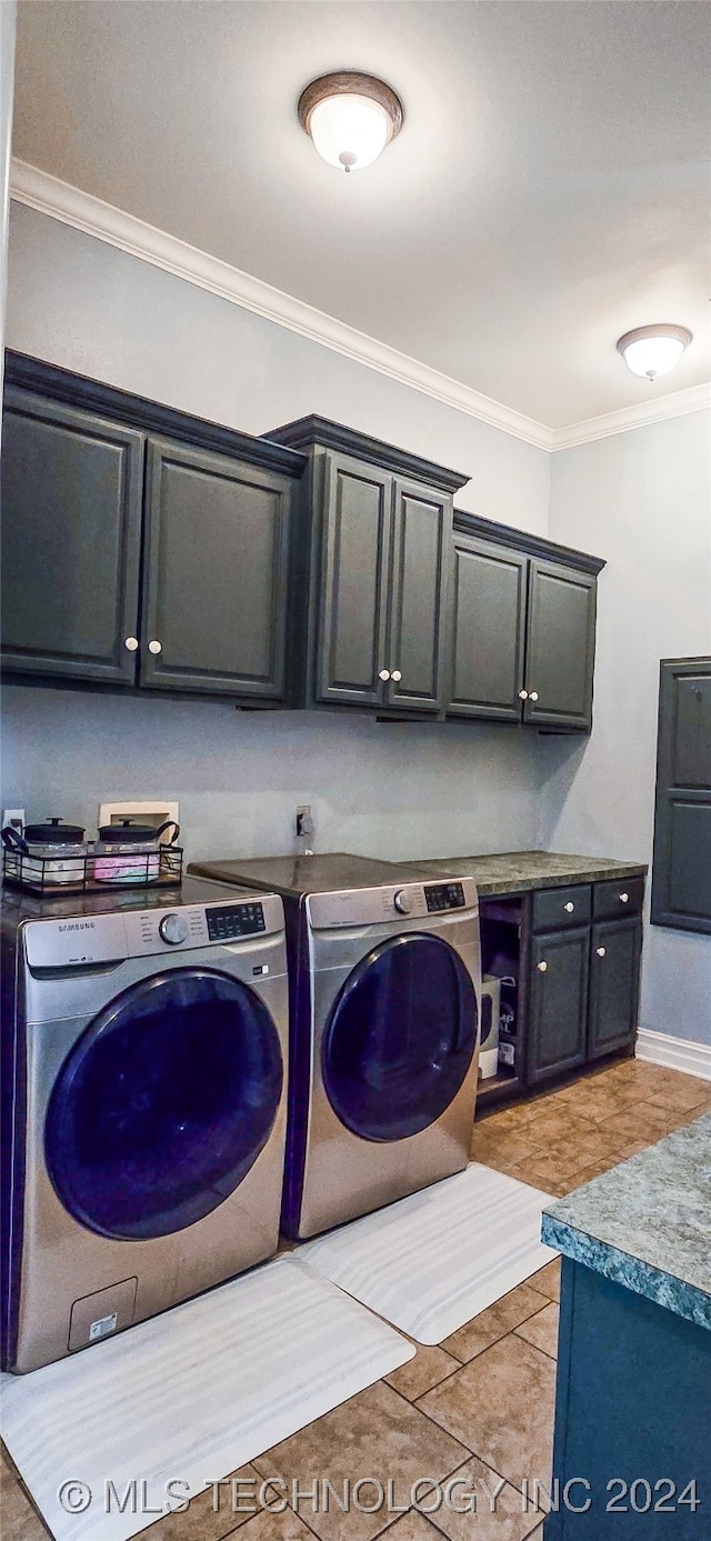 laundry area with crown molding, cabinets, separate washer and dryer, and light tile patterned floors