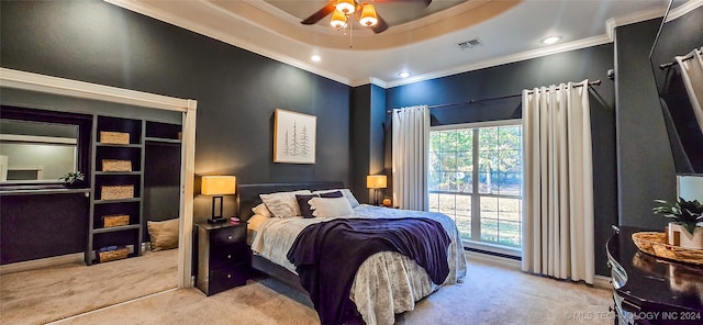 carpeted bedroom with ornamental molding, a raised ceiling, and ceiling fan