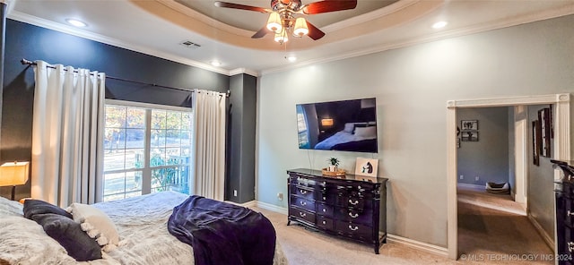 carpeted bedroom featuring crown molding, a raised ceiling, and ceiling fan