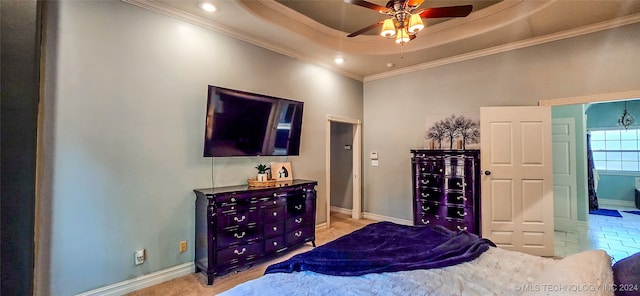 bedroom with crown molding, a tray ceiling, and ceiling fan