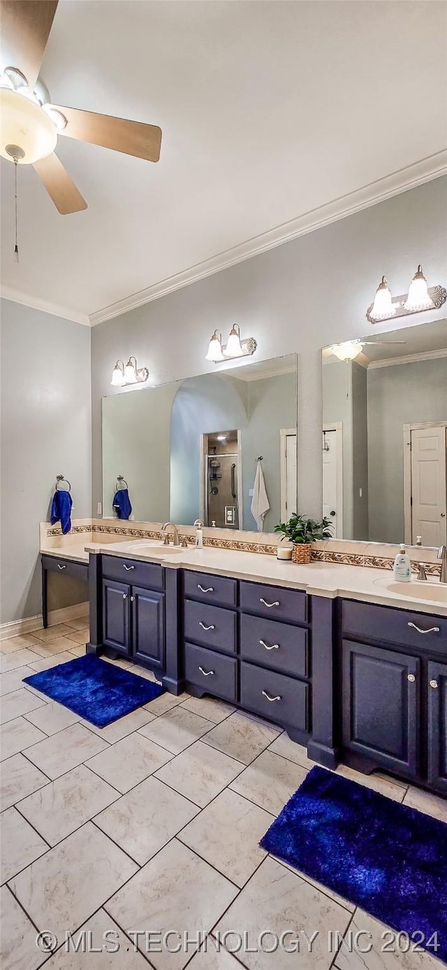 bathroom featuring crown molding, ceiling fan, vanity, and walk in shower