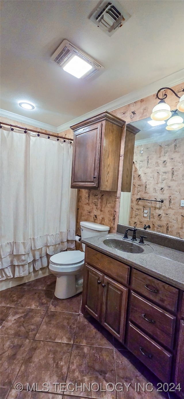 bathroom with vanity, crown molding, toilet, and tile patterned flooring