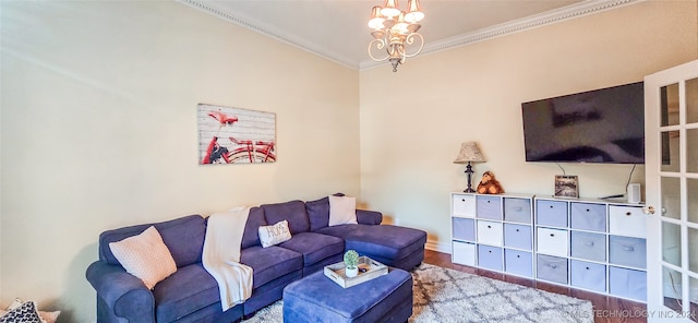 living room with ornamental molding, hardwood / wood-style flooring, and an inviting chandelier