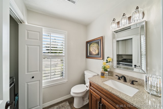 bathroom with vanity and toilet