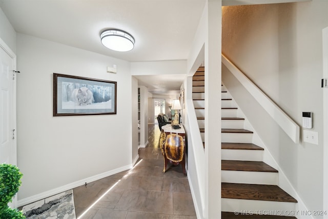 stairway featuring tile patterned flooring