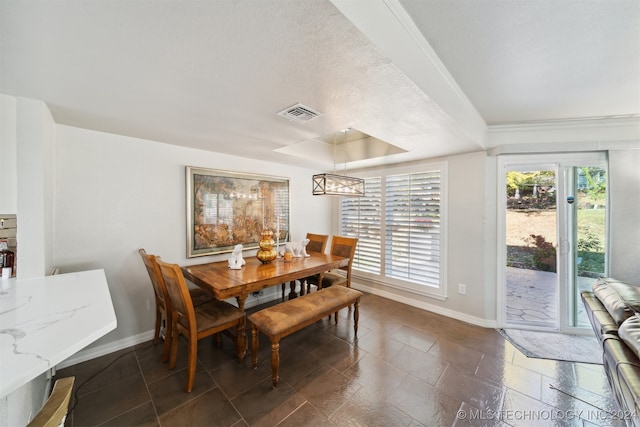 dining area featuring a textured ceiling