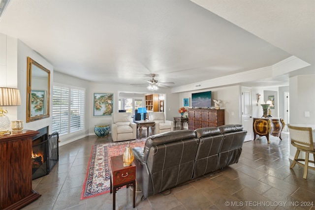 living room featuring ceiling fan and crown molding