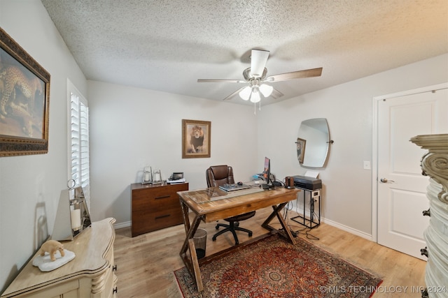 office space featuring light hardwood / wood-style flooring, a textured ceiling, and ceiling fan