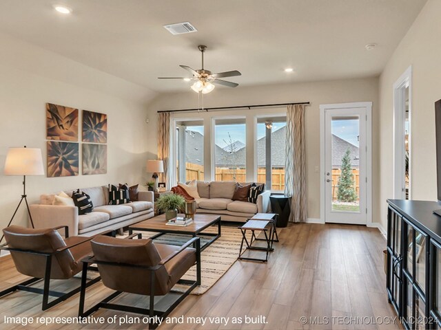 living room featuring a mountain view, hardwood / wood-style floors, a wealth of natural light, and lofted ceiling