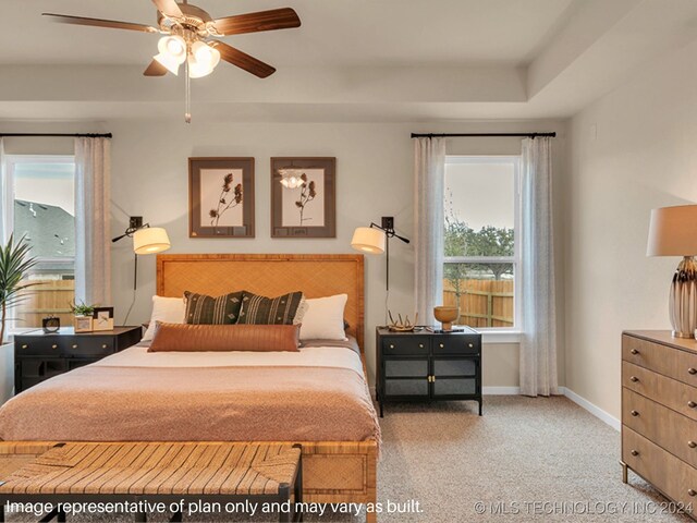 carpeted bedroom featuring ceiling fan and multiple windows