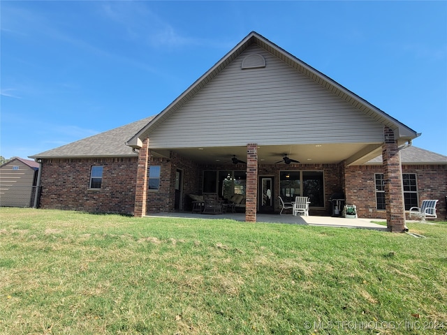 back of house with a yard, a patio area, and ceiling fan