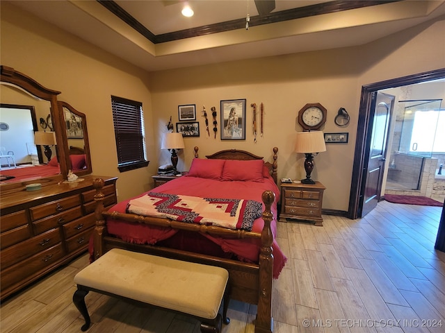 bedroom featuring crown molding, light hardwood / wood-style flooring, and ceiling fan