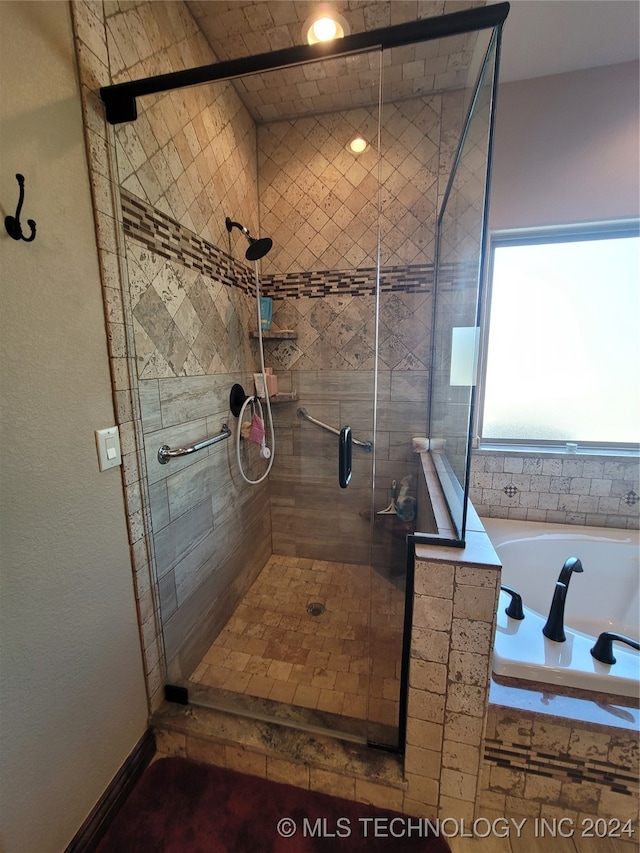 bathroom with shower with separate bathtub