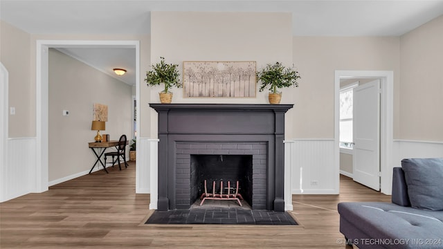 interior details with hardwood / wood-style flooring and a brick fireplace