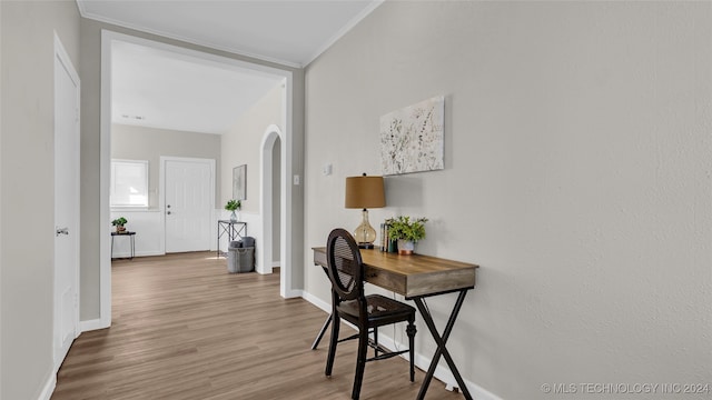 office area with wood-type flooring and ornamental molding