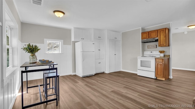 kitchen with light wood-type flooring and white appliances